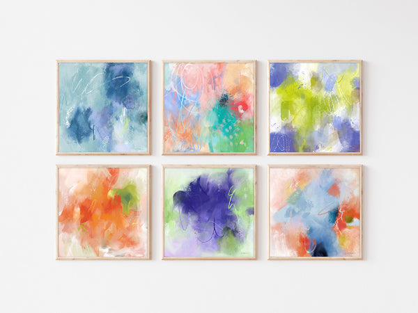 A gorgeous gallery wall that is filled with the color of blue, pinks, lavender and green. All saturated in color with chalky swirls added in.