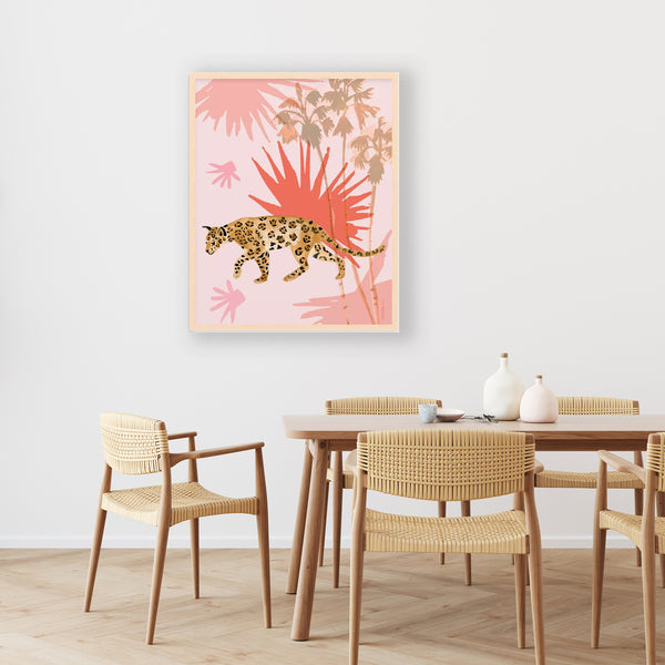 A jaguar set against a light pink background and large tropical leaves and palm trees
